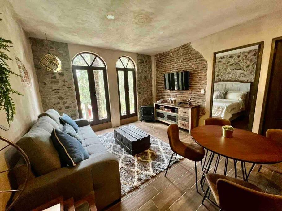 een woonkamer met een bank en een tafel bij Increíble Loft Completo en Val'Quirico in Santeagueda