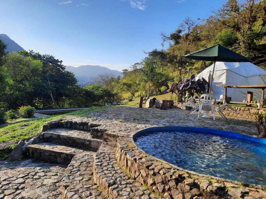 a backyard with a swimming pool and a tent at Casa Yantra La Lola in Pance