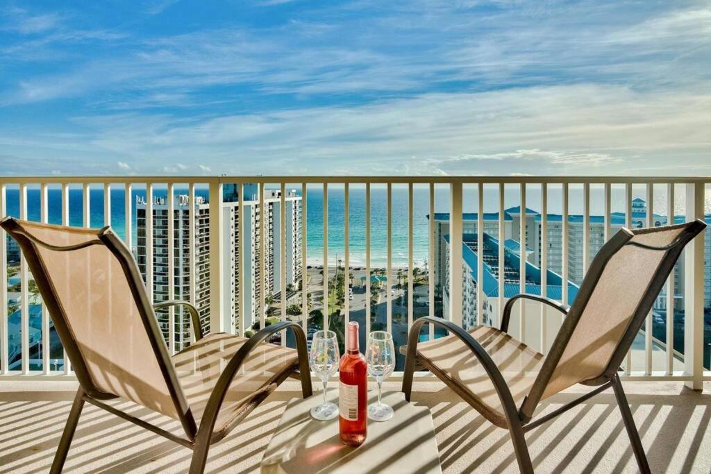 a balcony with two chairs and a bottle of wine at Beautiful beach home for a perfect vacation in Destin