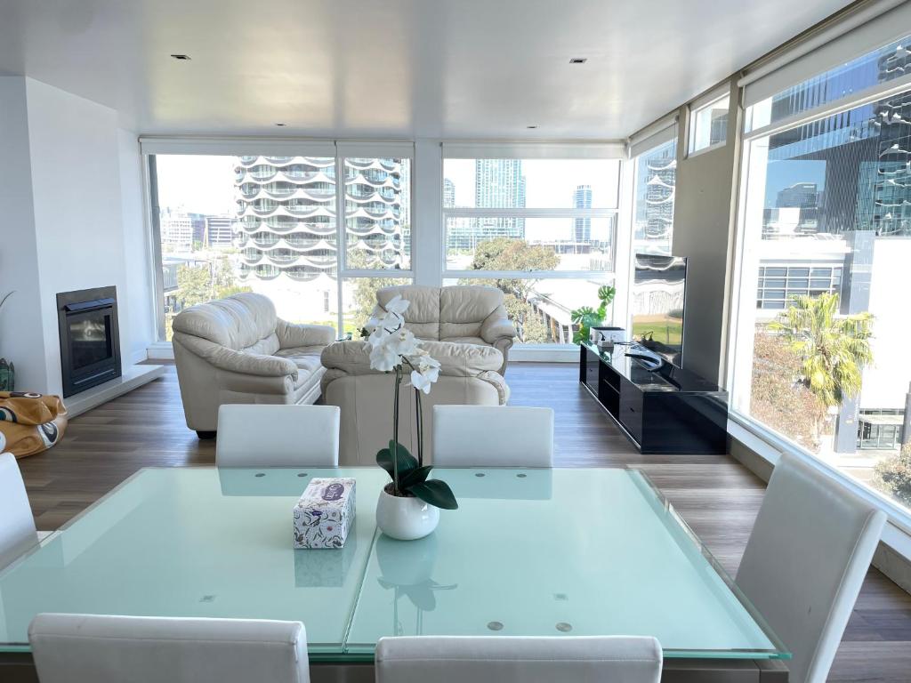 a living room with a table with two laptops on it at Docklands Luxury Penthouse Right Above The District Docklands in Melbourne