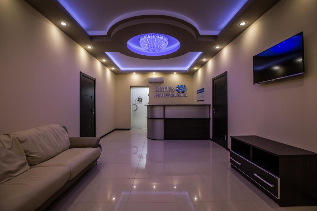 - un salon avec un canapé et un plafond bleu dans l'établissement Lotus Hotel & Spa, à Saratov