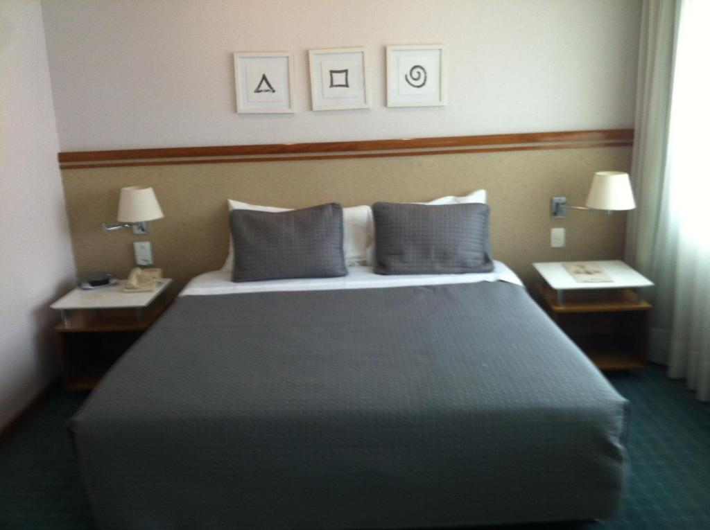 Cama o camas de una habitación en Flats na Vila Olimpia