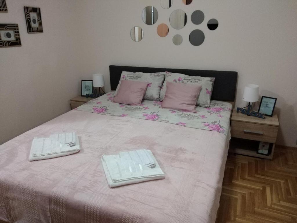 een slaapkamer met een bed met twee borden erop bij APARTMAN-STUDIO TEA SU in Subotica