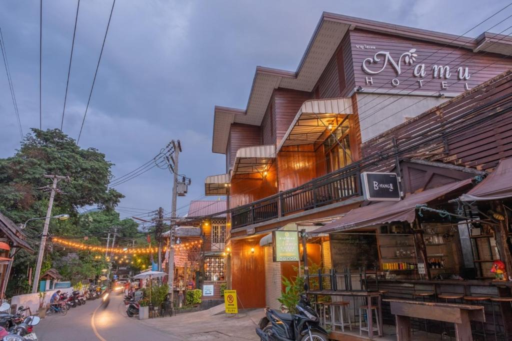 a building on a city street at night at Namu Hotel in Pai