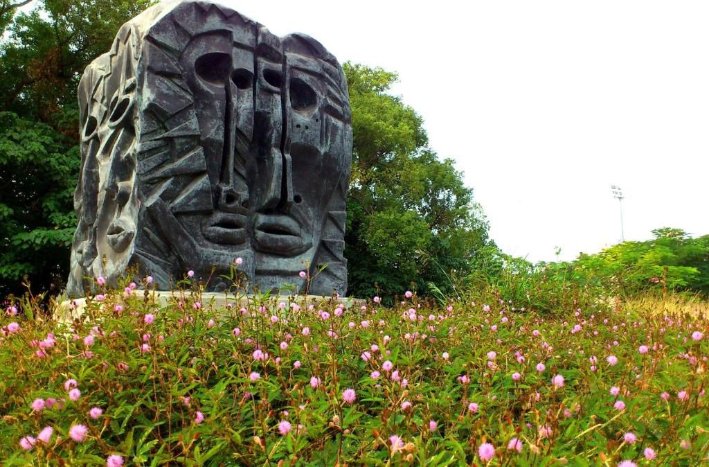 a statue in the middle of a field of flowers at Jin Lon Hotel in Taitung City