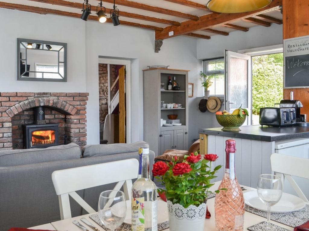 a living room with a couch and a fireplace at Chapel Farm Cottage in Wetwang