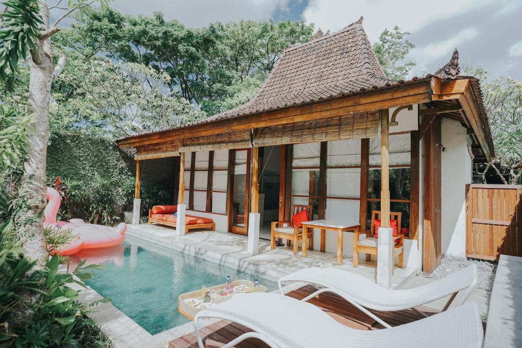 a villa with a pool and a house at Alam Bidadari Seminyak in Seminyak