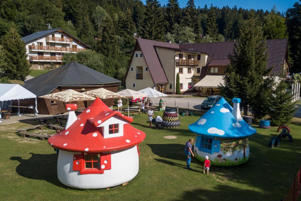 an outdoor play area with play structures in the grass at Chata Belez in Dolný Kubín