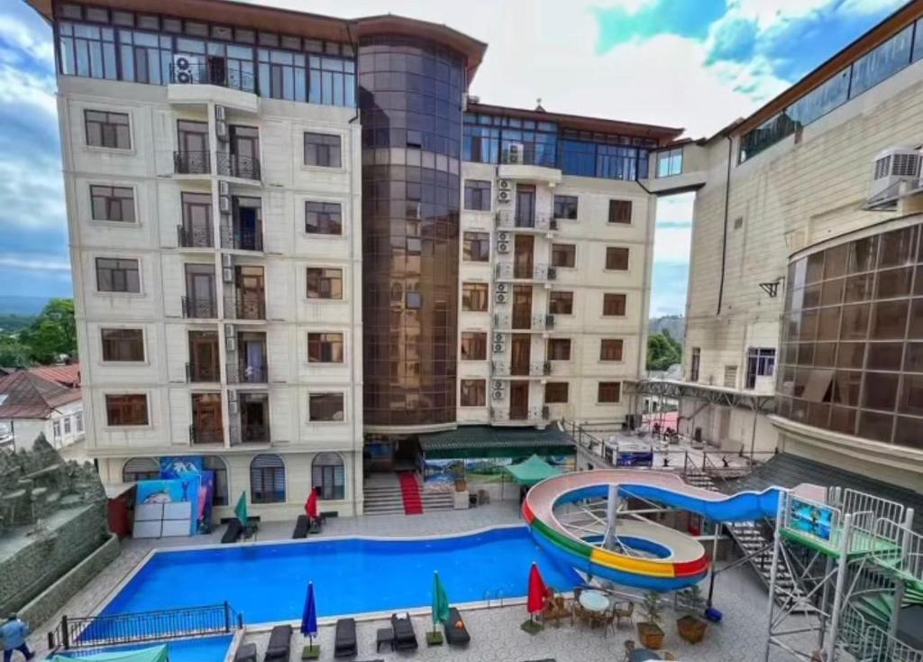 a large apartment building with a pool and a slide at Shahdag Quba & Truskavets in Quba