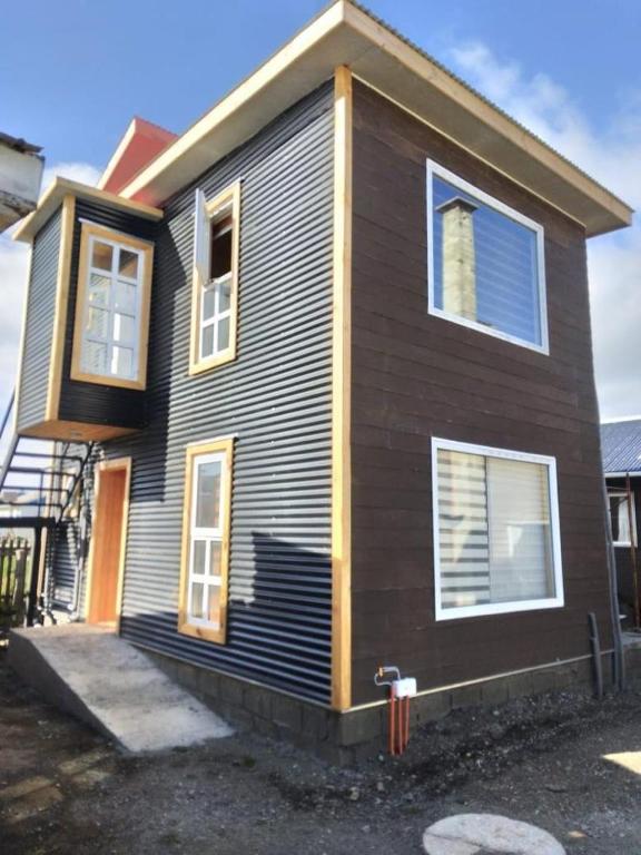 a brown house with a front porch and a door at Loft 644 in Porvenir