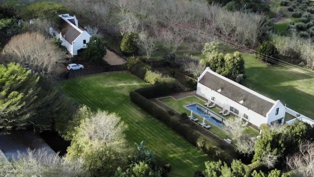 an aerial view of a house with a swimming pool at Jan Harmsgat Country House in Swellendam