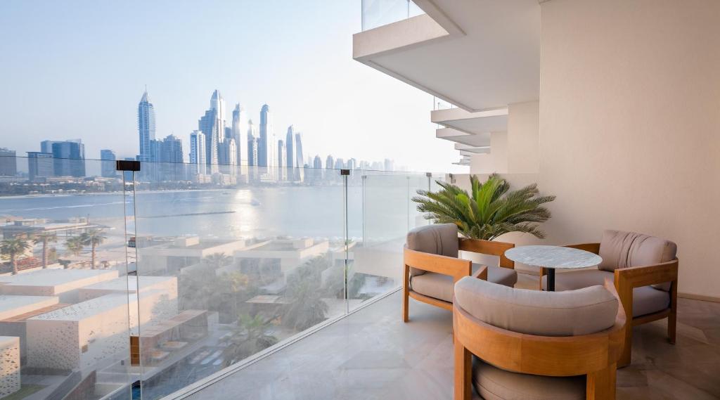 a dining room with a view of the city at Maison Privee - Luxury Sea View Apt in FIVE Resort on The Palm in Dubai