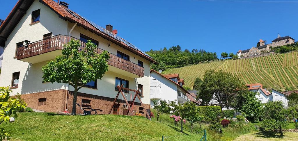 a house on a hill next to a vineyard at Ferienwohnung Annemarie in Gernsbach