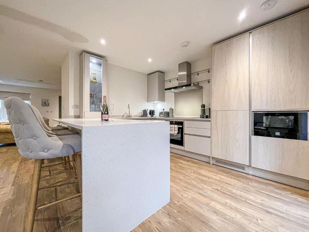 a kitchen with a white island in a room at Lavender Cottage in Stelling