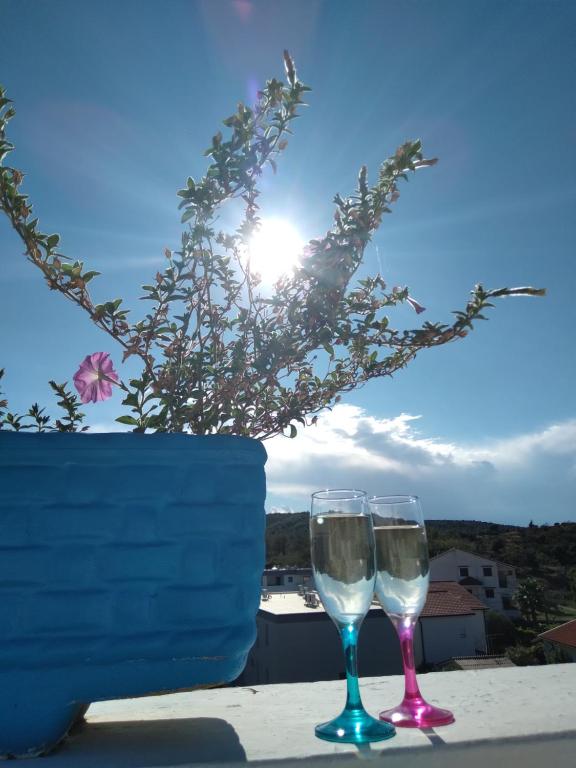 two wine glasses sitting on top of a table at Apartments "Sun-sea" in Rab
