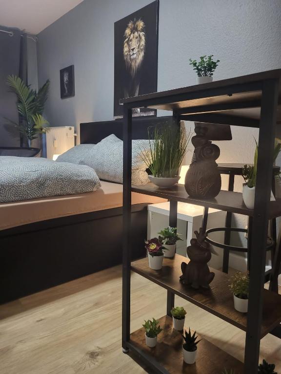 a room with a bed with potted plants on a shelf at Stadtnah an der Förde 116 in Flensburg