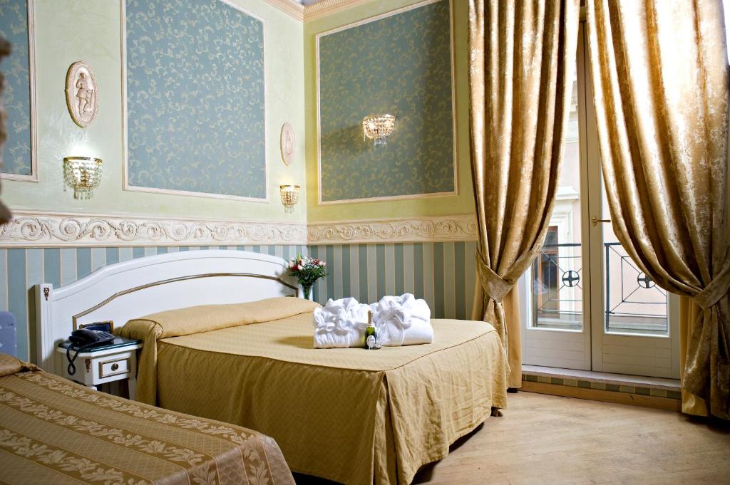 a bedroom with two beds with towels on them at Upper View Suite in Rome