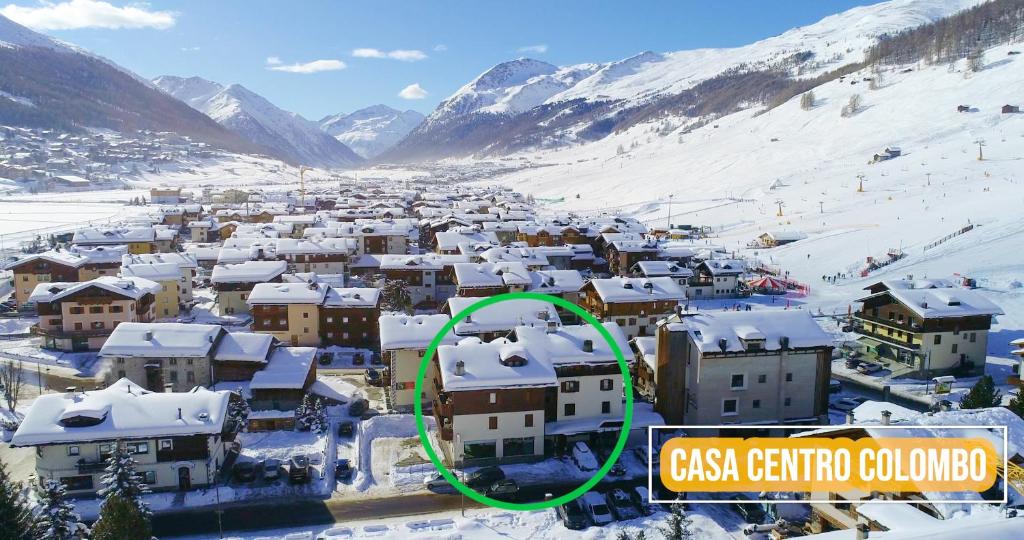 a village covered in snow with a green circle at Chalet Colombo MyholidayLivigno in Livigno