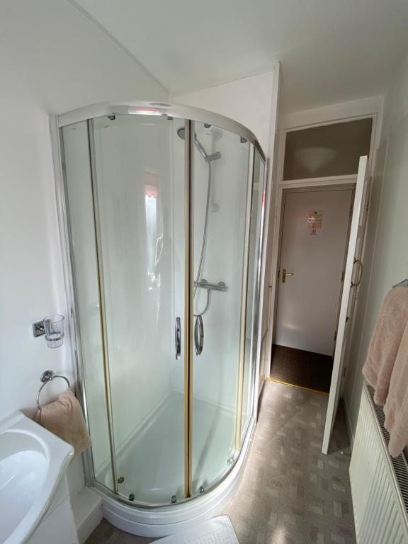 a bathroom with a shower and a sink at White Heather Guest House in Mablethorpe