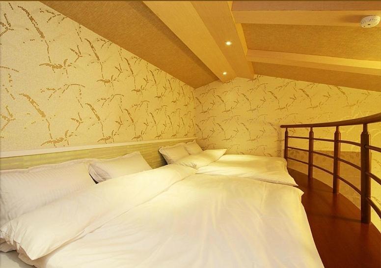 Postel nebo postele na pokoji v ubytování Zhuyuan Ju B&B