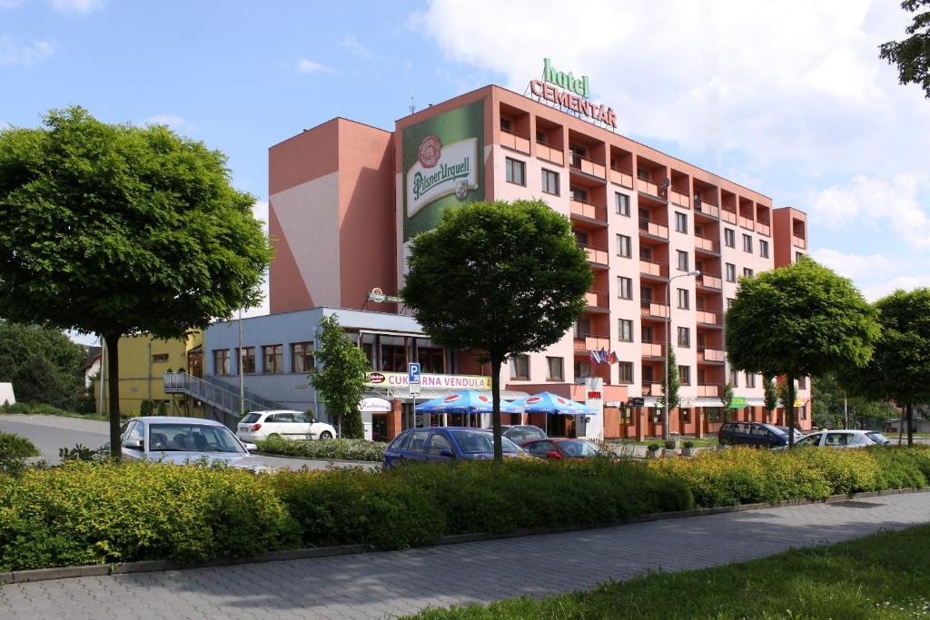 a hotel with cars parked in front of it at Hotel Cementář in Hranice