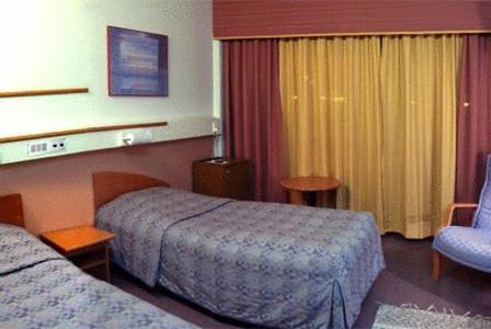 Hotelli Haapakannel tesisinde bir odada yatak veya yataklar
