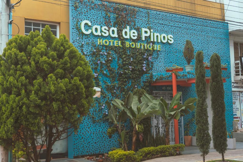 a blue building with a hotel sign on it at Casa de Pinos Hotel Boutique in Bucaramanga