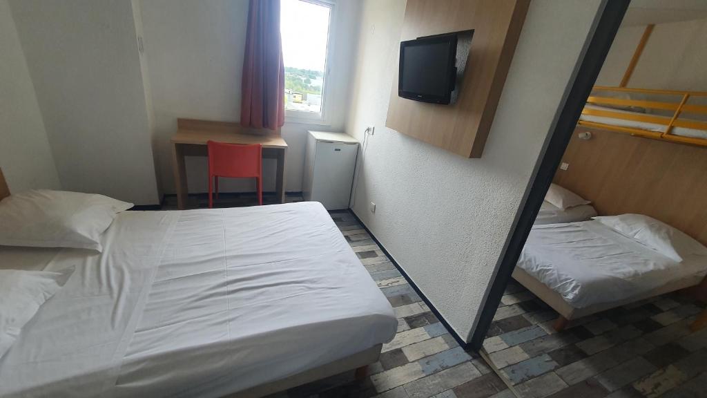 Postel nebo postele na pokoji v ubytování Welcomotel Limoges