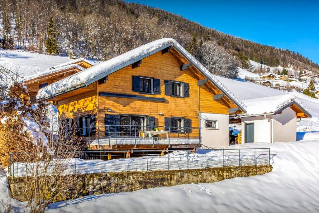 a log home with snow on the roof at Chalet Ysopi - OVO Network in Saint-Jean-de-Sixt