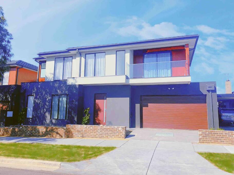 a large blue house with a garage at ‘The bayside’ Beautifully brand new house in Mentone