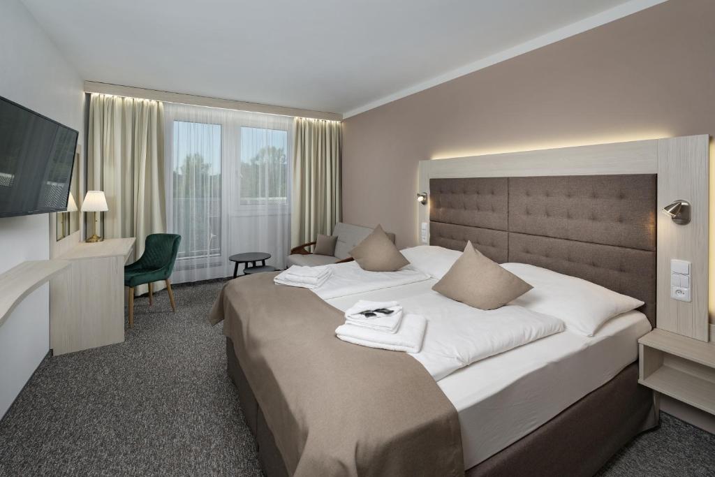 Postel nebo postele na pokoji v ubytování Wellness Hotel Astra