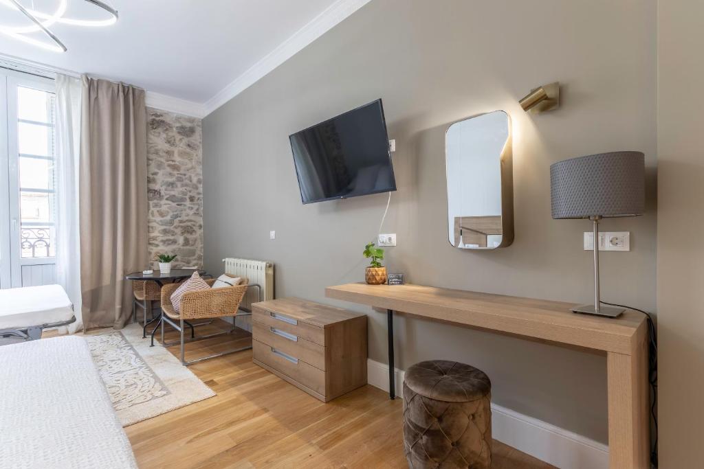 Телевизор и/или развлекательный центр в Habitaciones Apartamento B&B Plaza Nueva 8