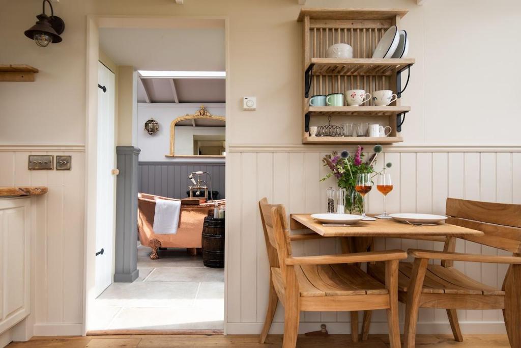 a kitchen and dining room with a table and chairs at Wagtail in Greenhead