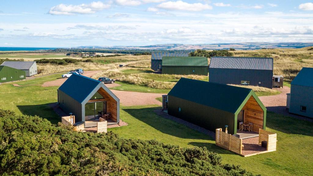 an aerial view of a house on a field at Lodges at Whitekirk Hill some with Hot Tubs - North Berwick in Whitekirk