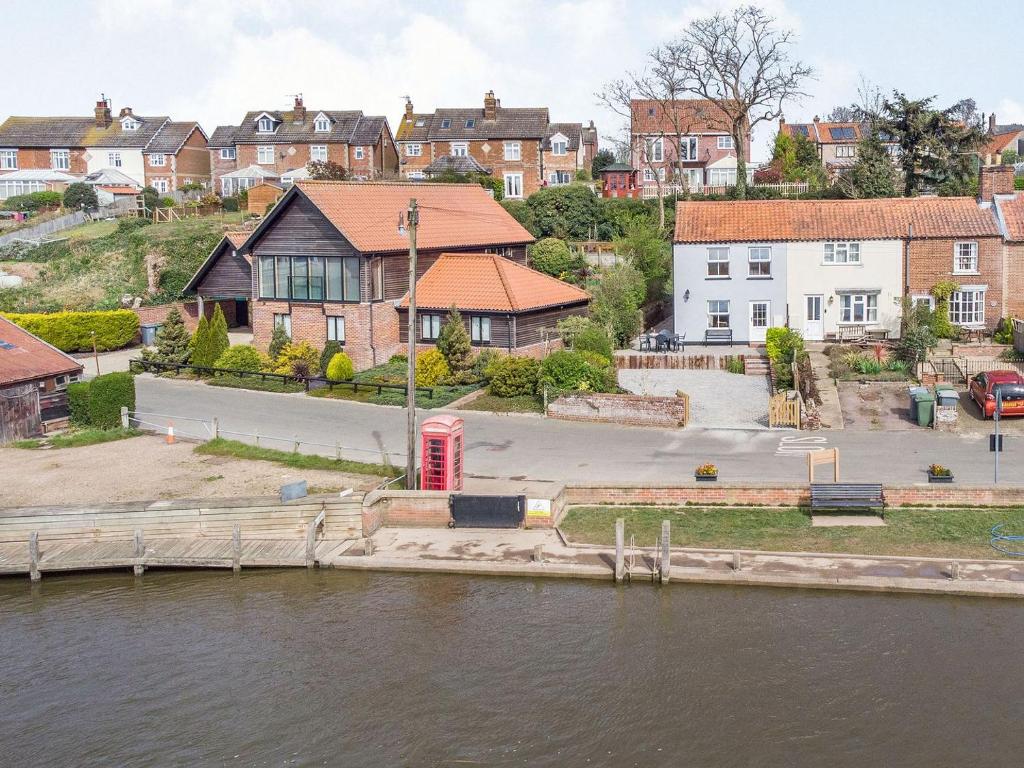 a group of houses next to a body of water at Quay End in Reedham