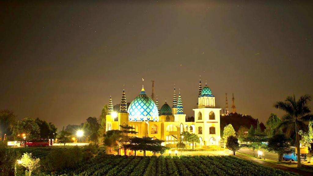 a large building with blue domes at night at Lembah Ciater Resort Managed by Sahid in Ciater