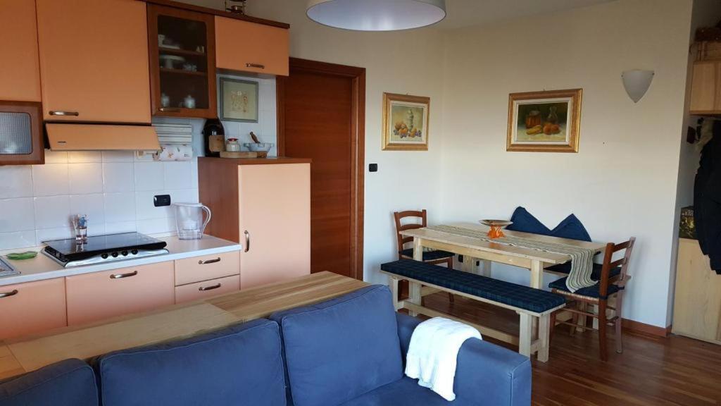 a living room with a blue couch and a table at The Panoramico in Sauze dʼOulx