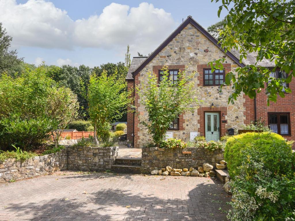 an old brick house with a stone driveway at Barley Cottage in Axminster