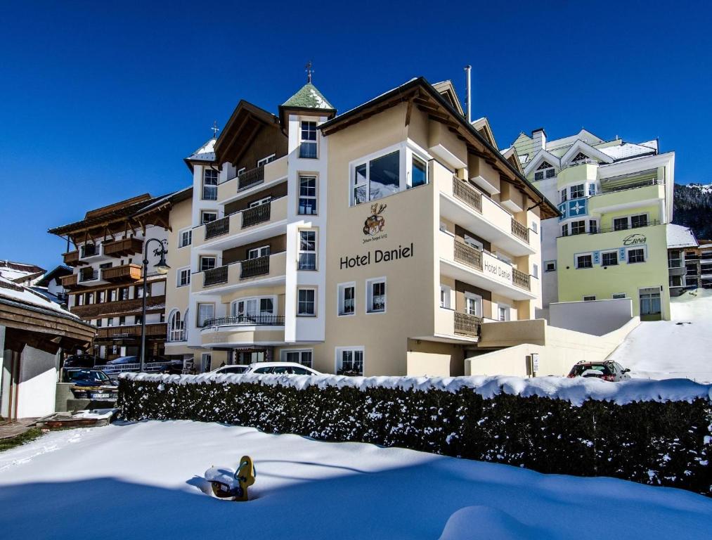 a hotel building with snow in front of it at Hotel Garni Daniel in Ischgl