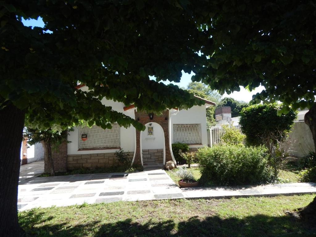 
a house with a tree in front of it at Holiday Home Mi Refugio in Mar del Plata
