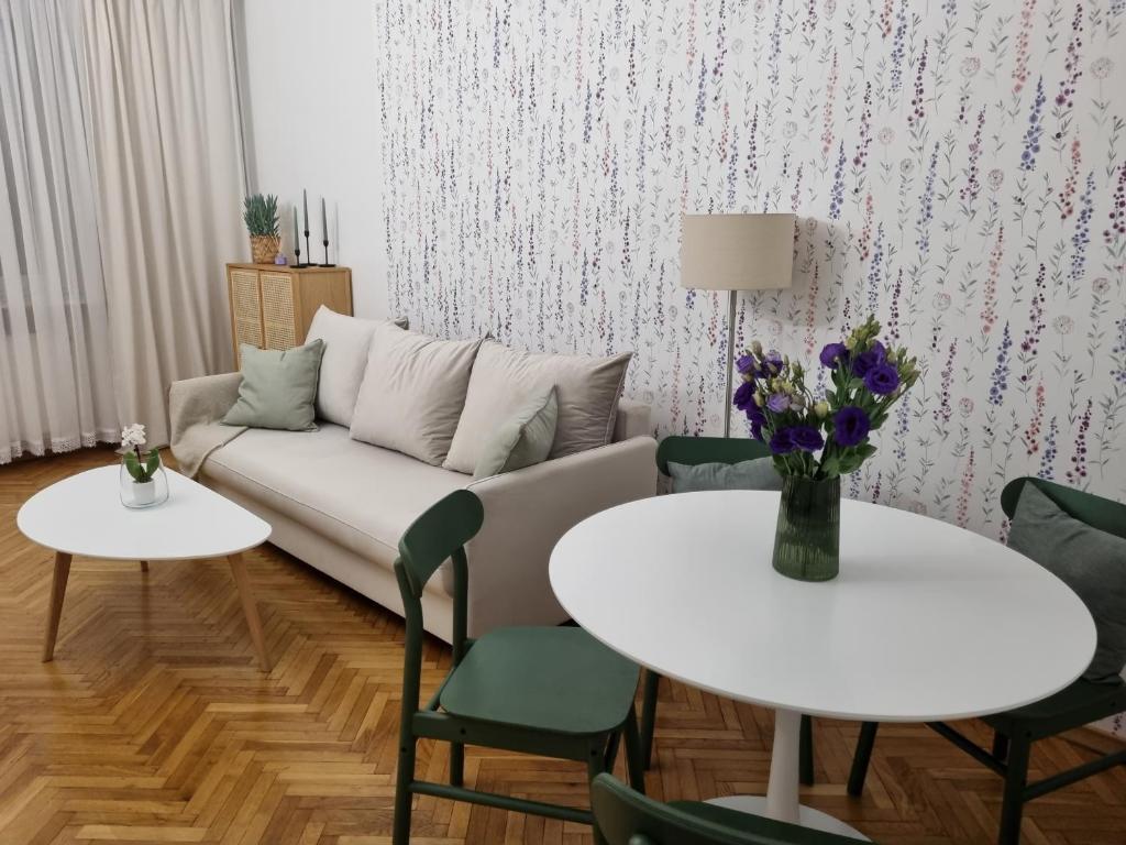 ein Wohnzimmer mit einem Sofa und 2 Tischen in der Unterkunft Apartament na Żeromskiego in Gdynia