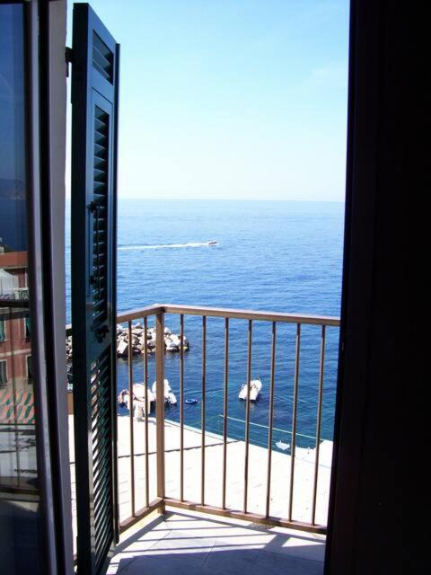 a view of the ocean from a balcony of a building at CasaRiomaggiore "a few steps from the sea" in Riomaggiore