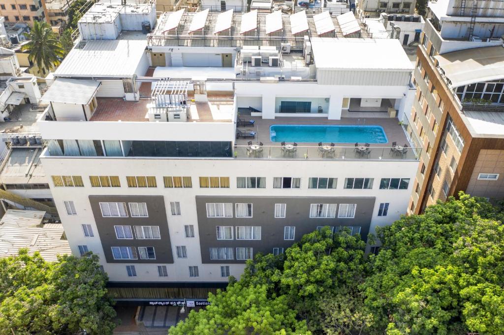 an aerial view of a building with a swimming pool at Zion - A Luxurious Hotel in Bangalore