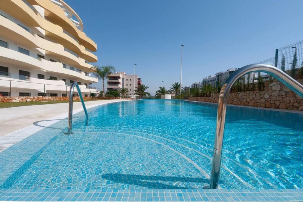 a swimming pool in the middle of a building at Premium Apartment with Swimming pool by Aparters in Arenales del Sol