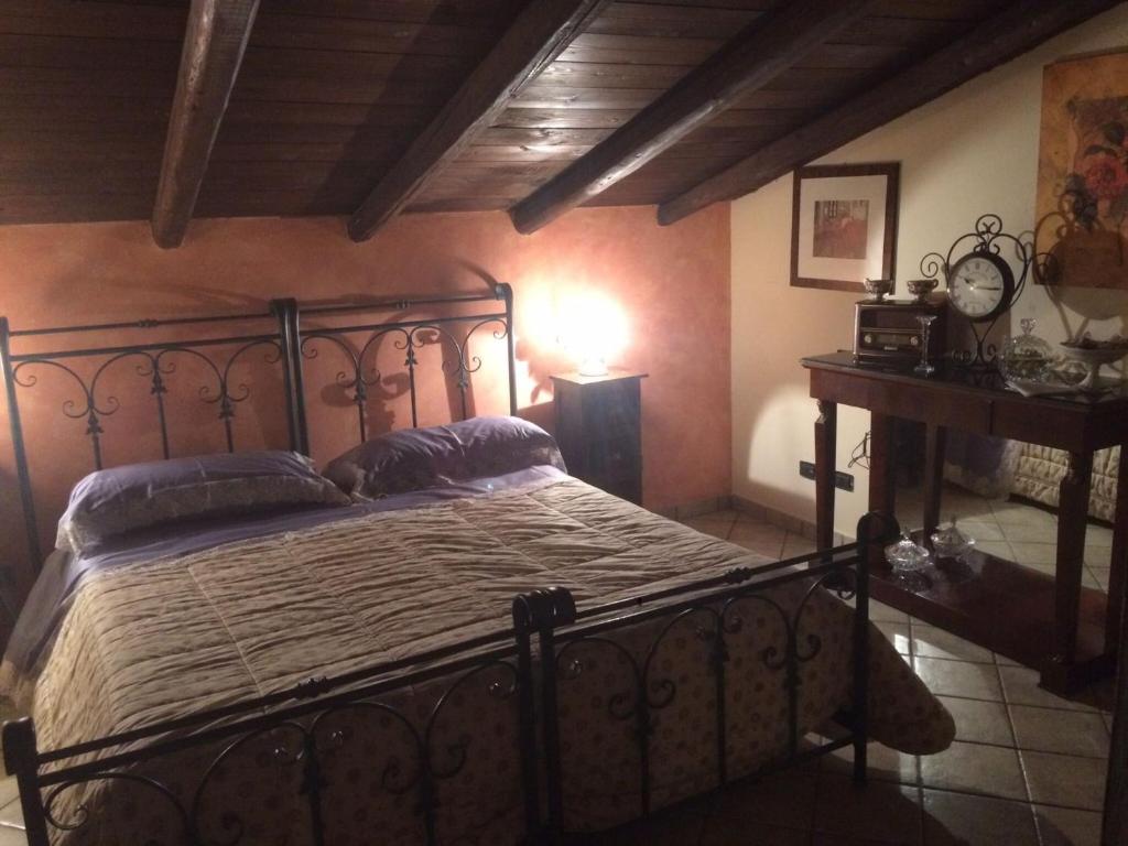 a bedroom with a large bed in a room at Baglio Zio Ciccio in Altavilla Milicia