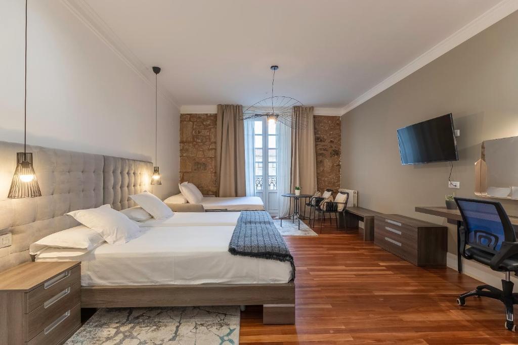 Кровать или кровати в номере Habitaciones Apartamento B&B Plaza Nueva 8