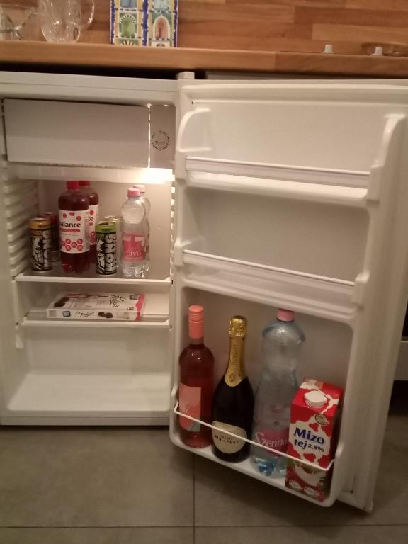 an open refrigerator filled with lots of drinks and alcohol at Hungaricum Budapest in Budapest