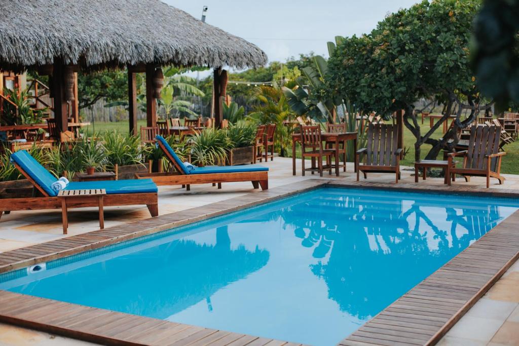 a pool with chairs and tables and a resort at VILA ATY LODGE in Atins