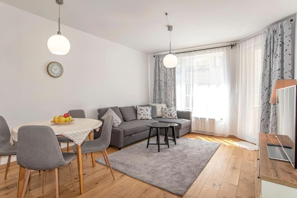 a living room with a couch and a table at Designed Apartment in Central Sofia in Sofia