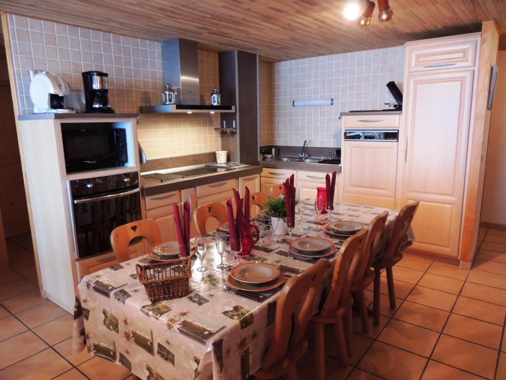 a kitchen with a table and chairs and a kitchen with a table and chairsktop at Les Gets : Appt 10 pers skis aux pieds, balcon, parking, wifi - FR-1-598-72 in Les Gets